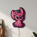 Unlit Pink Stitch LED lightbox mounted on a wall in daylight