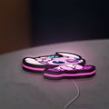 Pink Stitch LED lightbox lying flat on a desk with pink glow