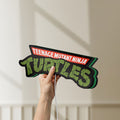 Unlit Turtles LED lightbox held by hand to show size and details