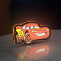 Lightning McQueen LED lightbox standing on a desk from an angled side view with orange glow