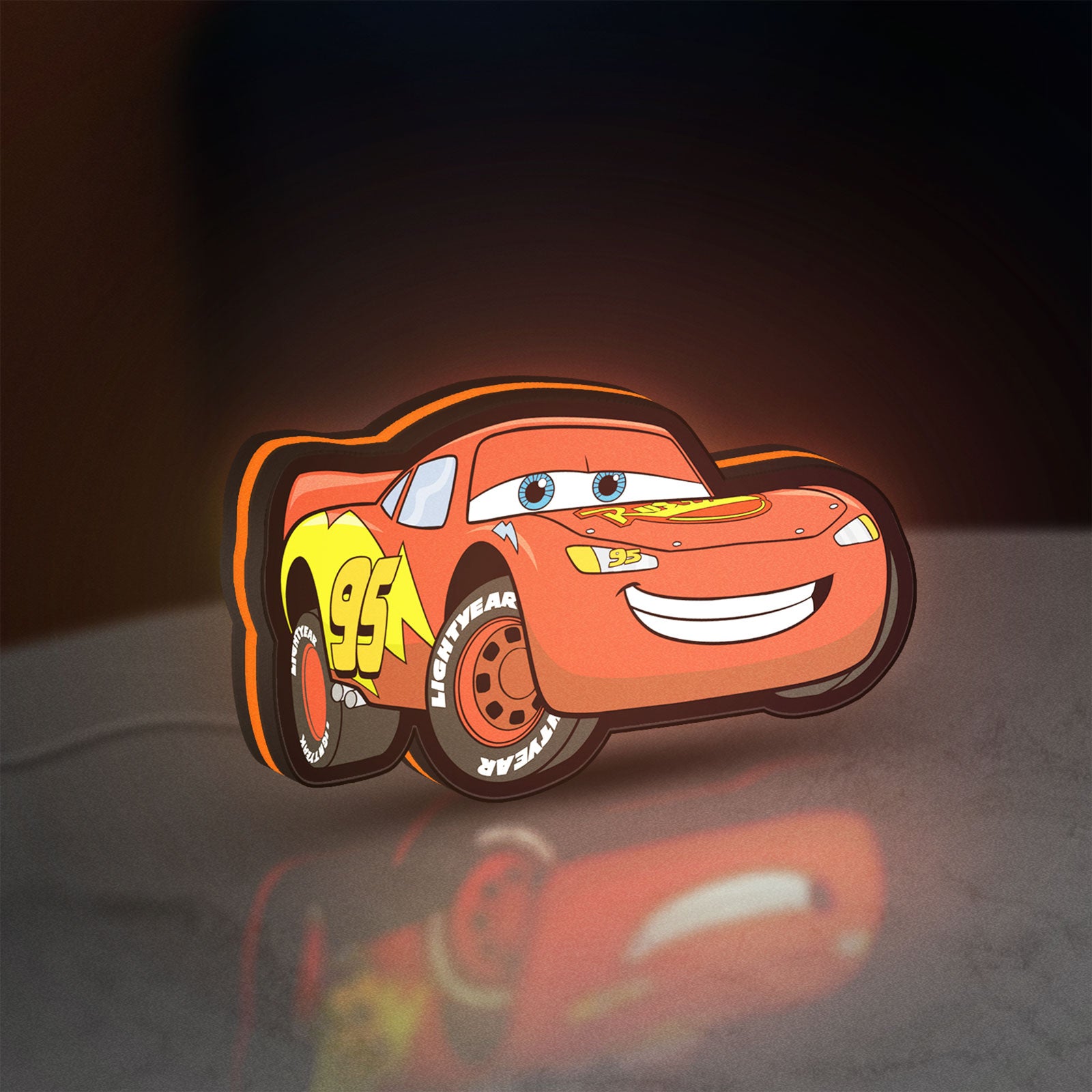 Lightning McQueen LED lightbox standing on a desk from an angled side view with orange glow