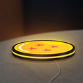 4 Star Dragon Ball LED lightbox lying flat on a desk with yellow glow