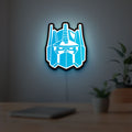 Optimus Prime LED lightbox hanging on a room wall with soft blue light