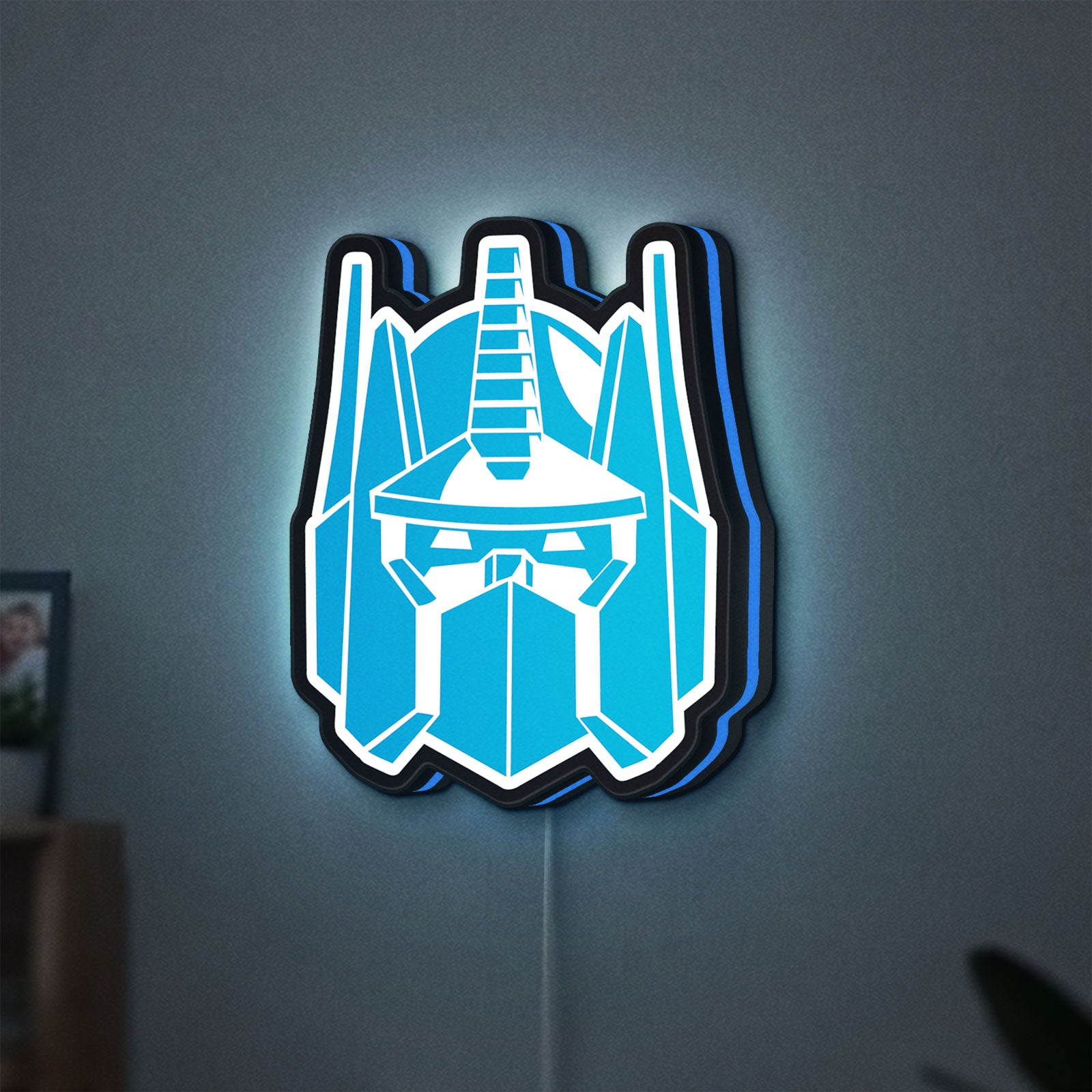 Optimus Prime LED lightbox hanging on a wall with blue glow