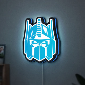 Optimus Prime LED lightbox hanging on a wall with blue glow