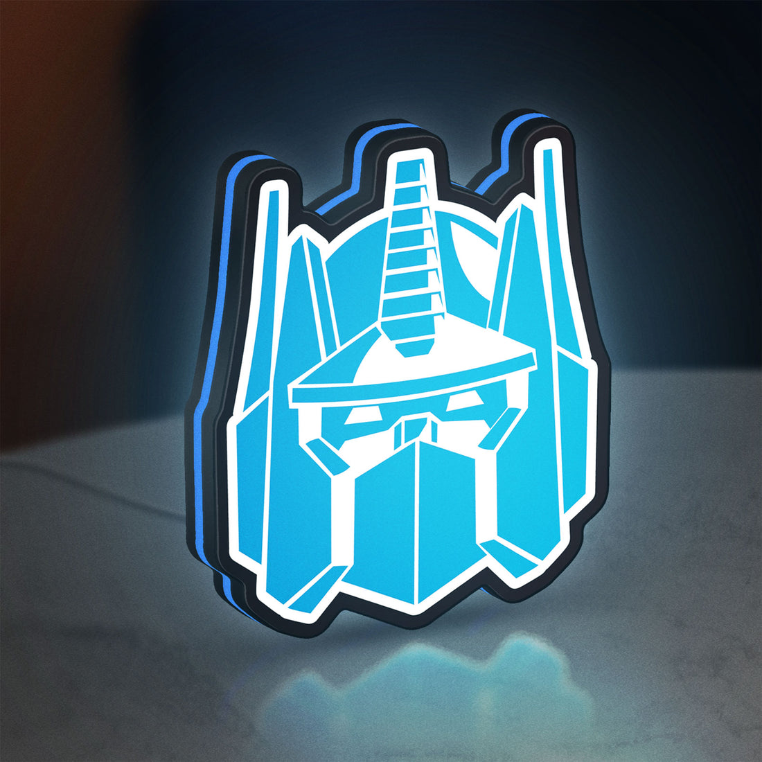 Optimus Prime LED lightbox hanging on a wall with blue glow