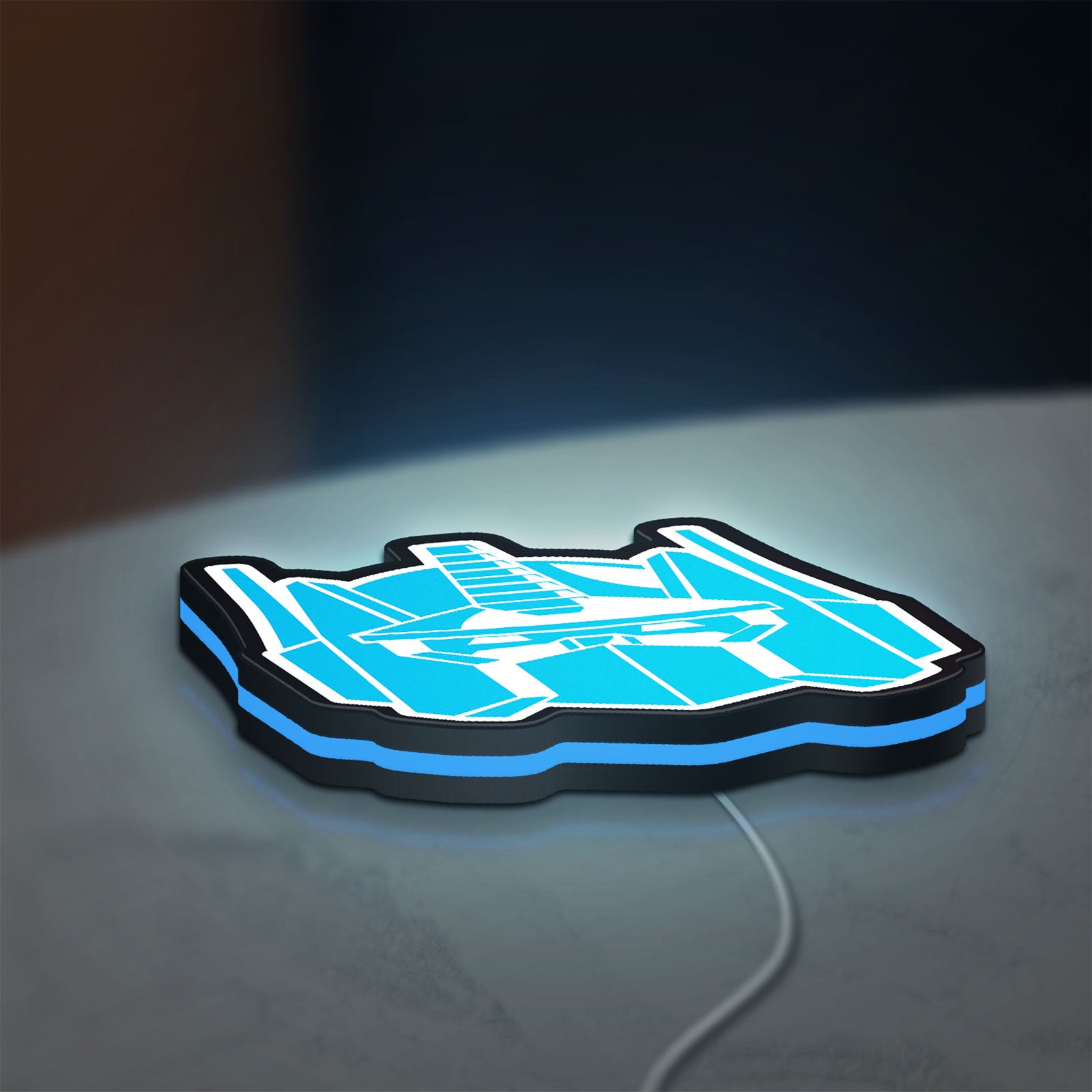 Optimus Prime LED lightbox lying flat on a desk with blue glow