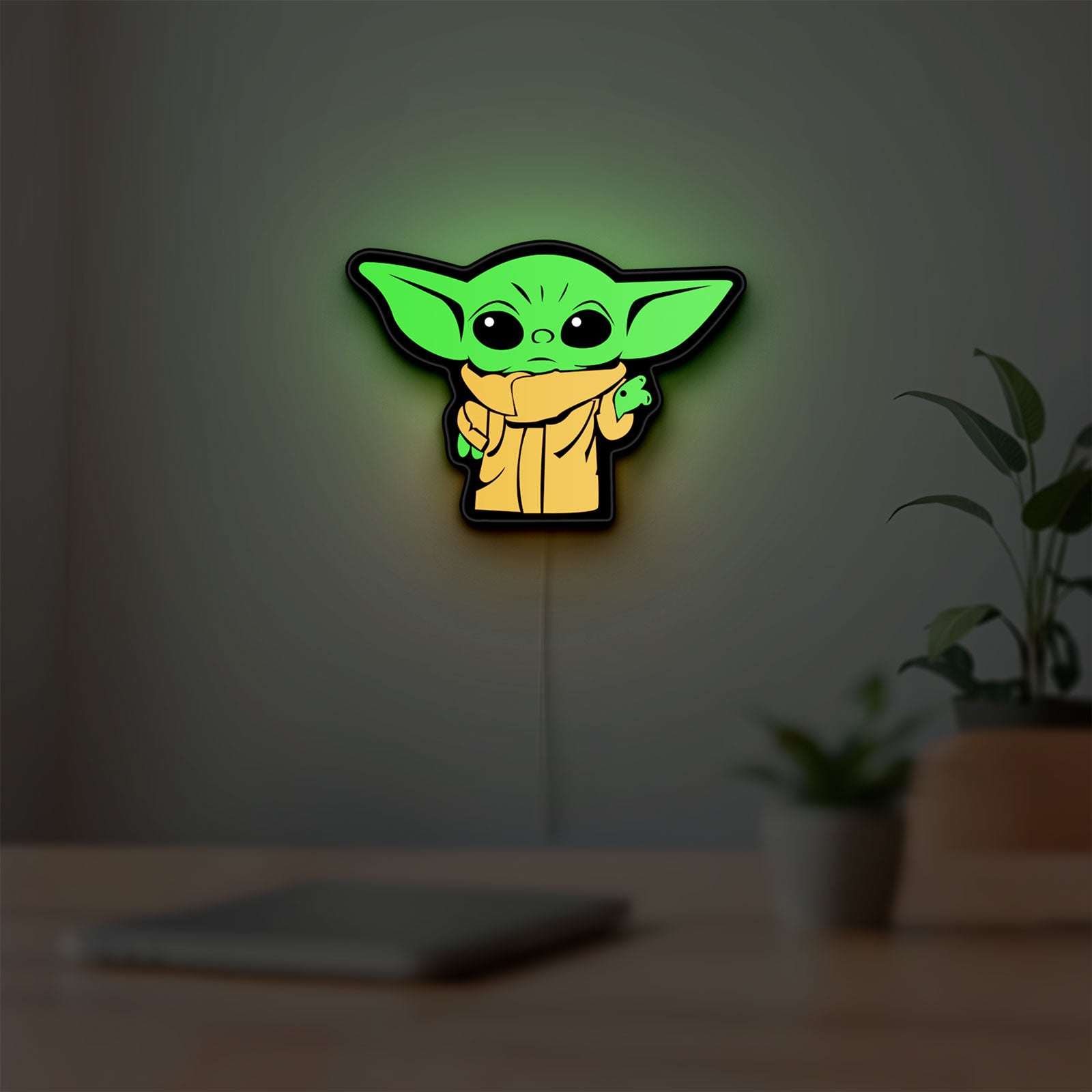 Grogu The Child LED lightbox hanging on a room wall with soft green light