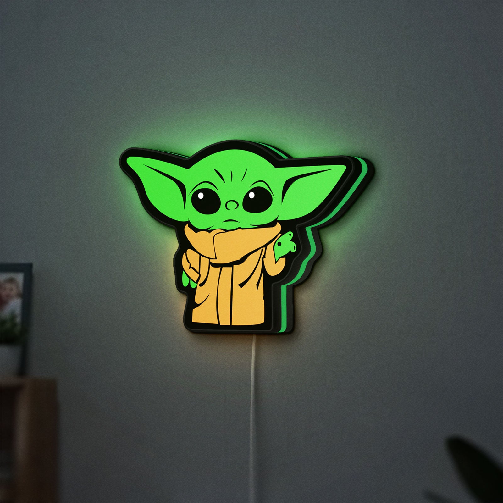 Grogu The Child LED lightbox hanging on a wall with green glow