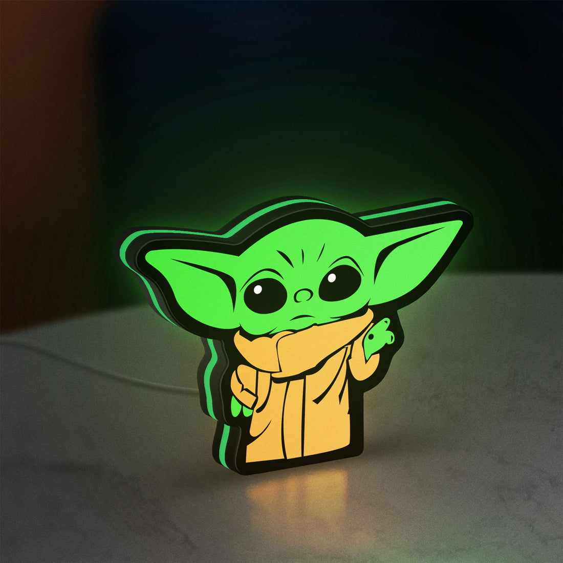 Grogu The Child LED lightbox hanging on a wall with green glow