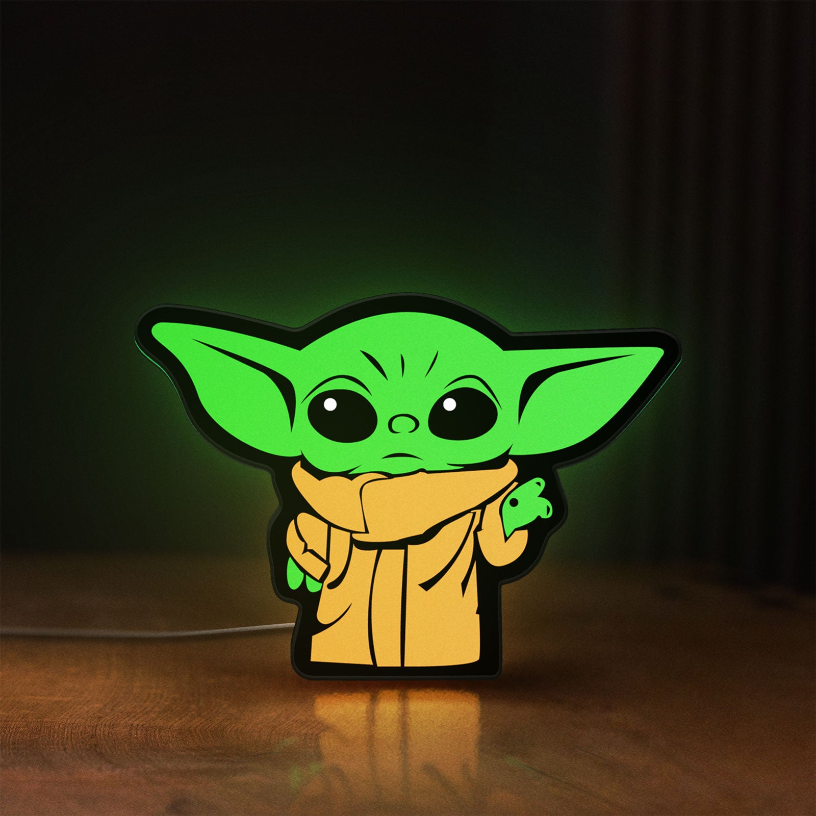 Front view of Grogu The Child LED lightbox sign glowing on a wooden desk