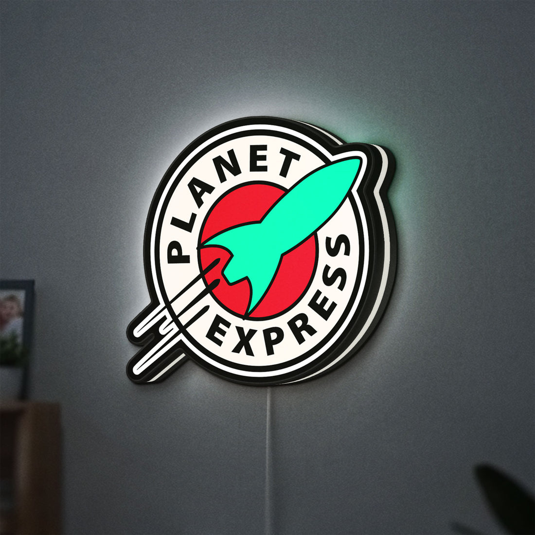 Planet Express LED lightbox hanging on a wall with white glow