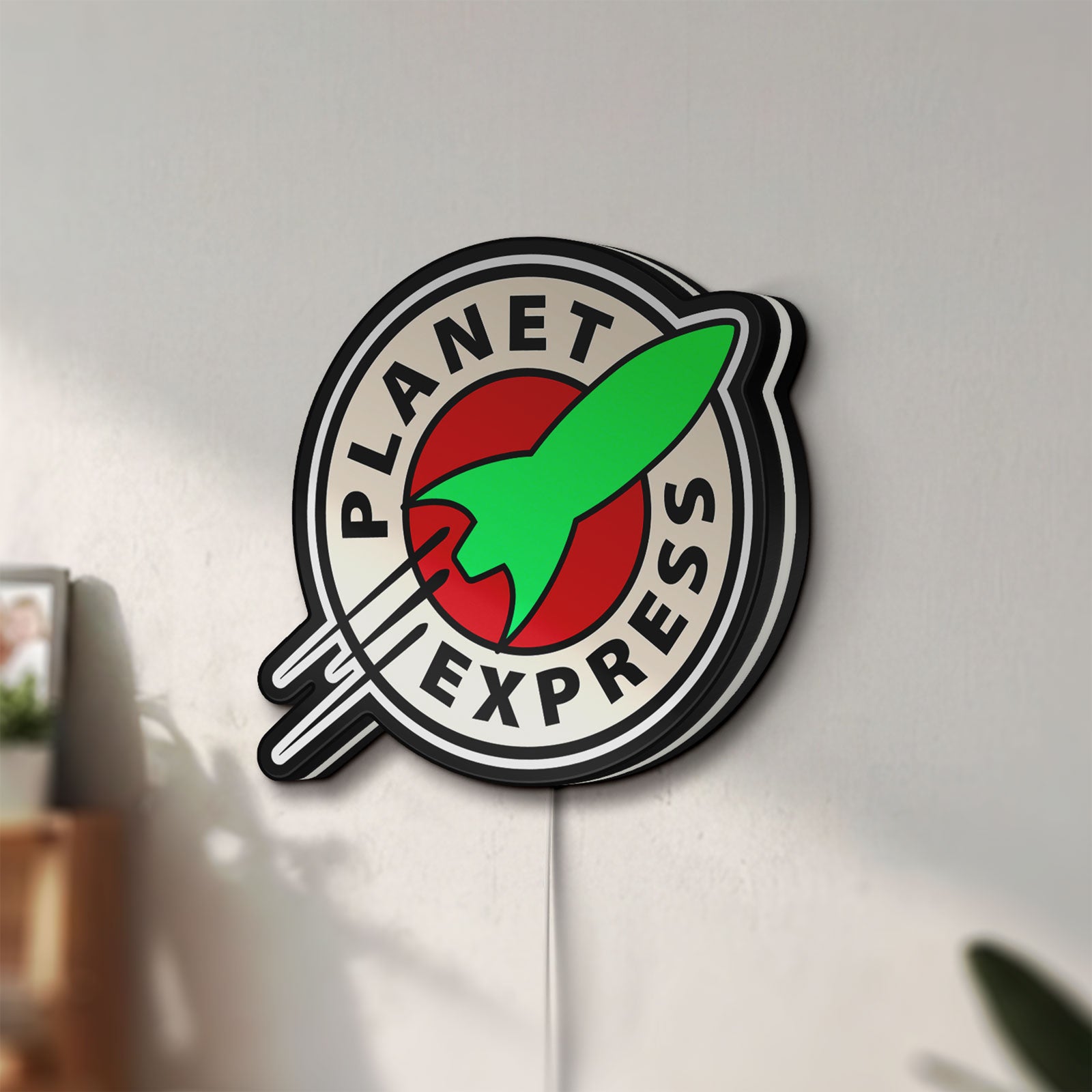 Unlit Planet Express LED lightbox mounted on a wall in daylight