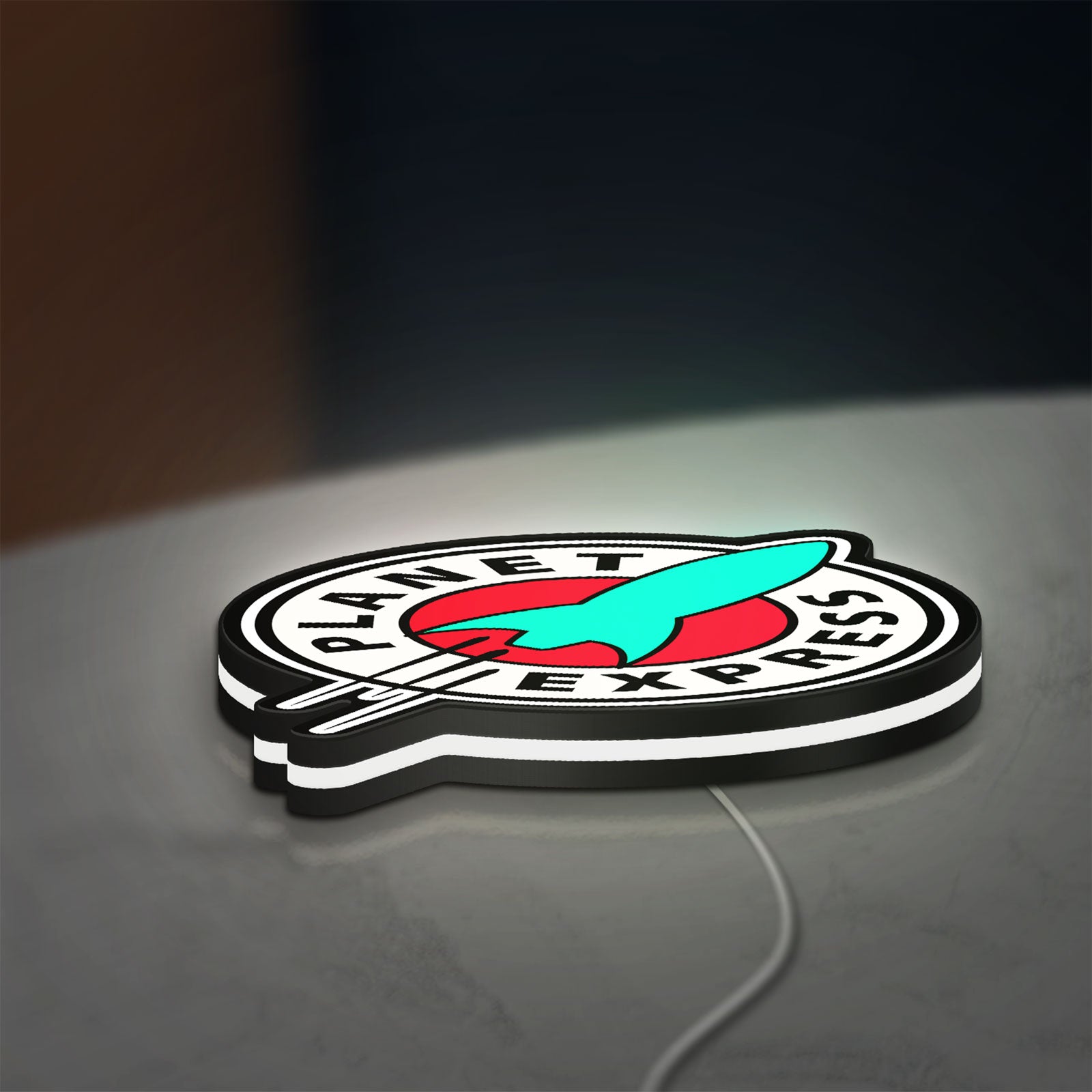 Planet Express LED lightbox lying flat on a desk with white glow