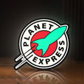 Front view of Planet Express LED lightbox sign glowing on a wooden desk
