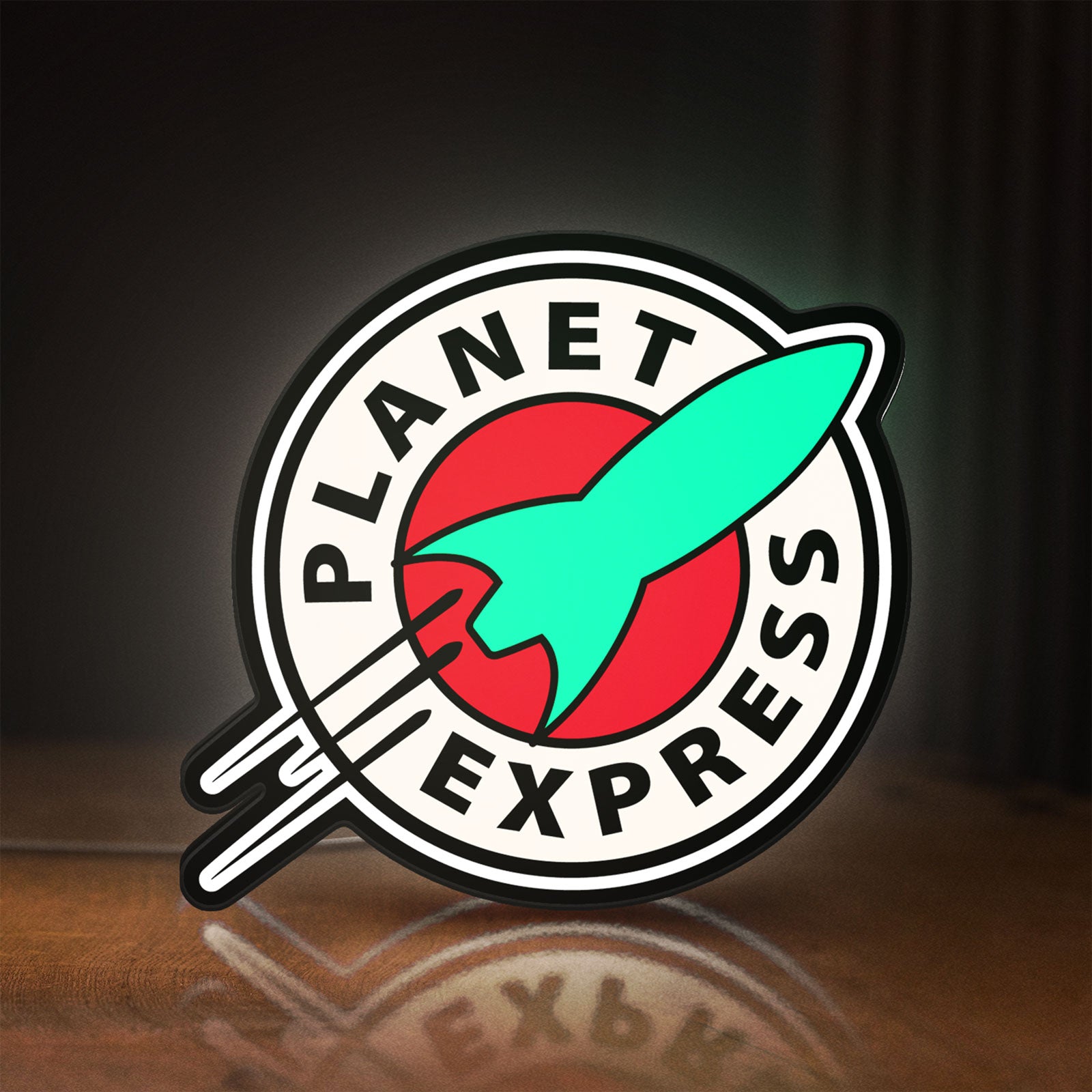 Front view of Planet Express LED lightbox sign glowing on a wooden desk