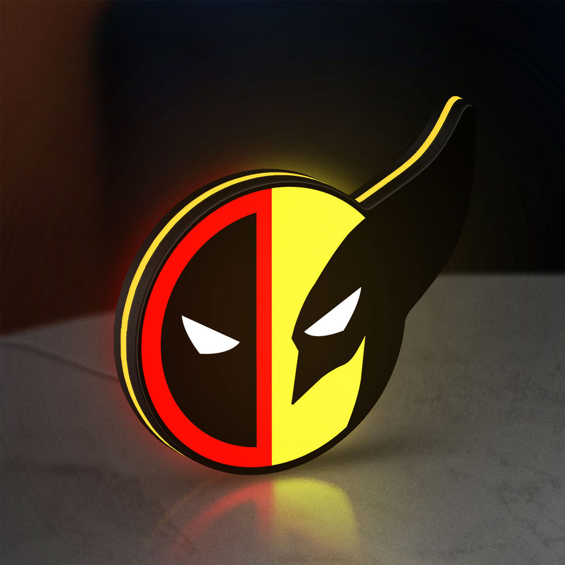 Deadpool & Wolverine Icon LED lightbox hanging on a wall with yellow glow