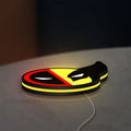 Deadpool & Wolverine Icon LED lightbox lying flat on a desk with yellow glow