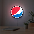 Pepsi LED lightbox hanging on a room wall with soft white light