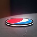 Pepsi LED lightbox lying flat on a desk with white glow