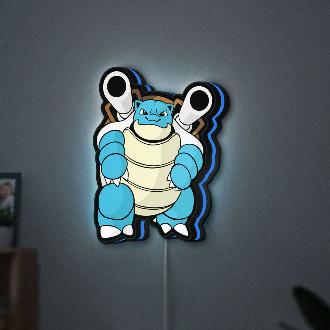 Blastoise LED lightbox hanging on a wall with blue glow