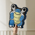 Unlit Blastoise LED lightbox held by hand to show size and details