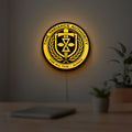 TVA LED lightbox hanging on a room wall with soft yellow light