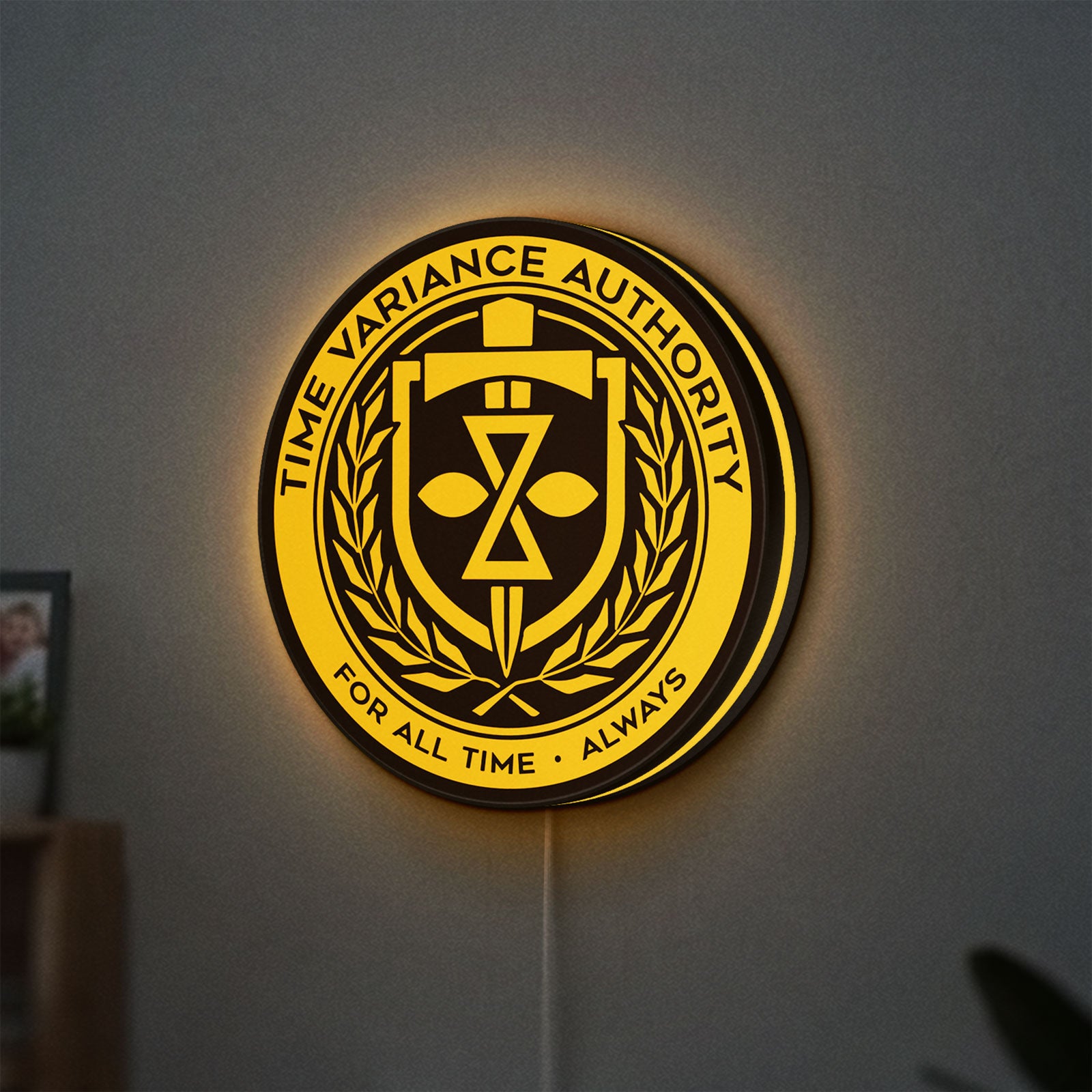 TVA LED lightbox hanging on a wall with yellow glow