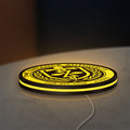 TVA LED lightbox lying flat on a desk with yellow glow