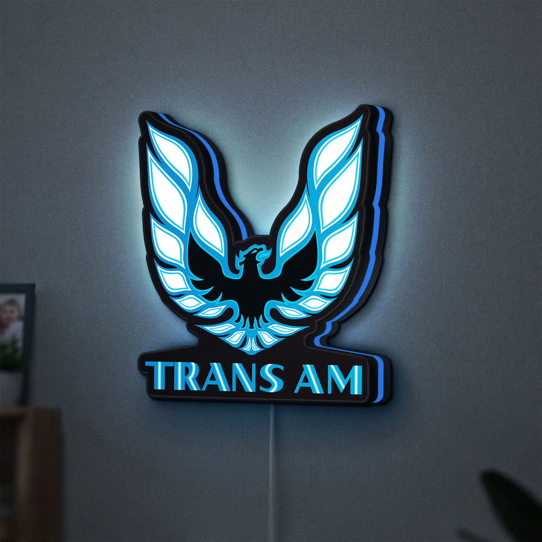 Trans Am LED lightbox hanging on a wall with blue glow