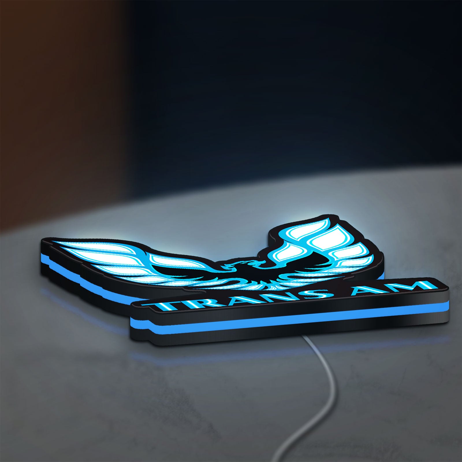 Trans Am LED lightbox lying flat on a desk with blue glow