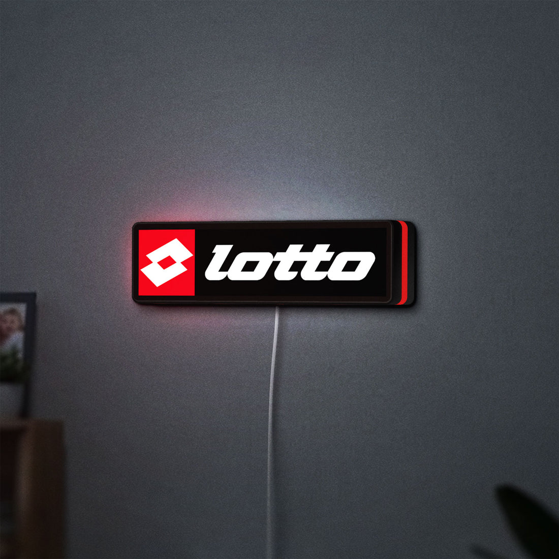 Lotto LED lightbox hanging on a wall with red glow