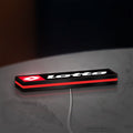 Lotto LED lightbox lying flat on a desk with red glow