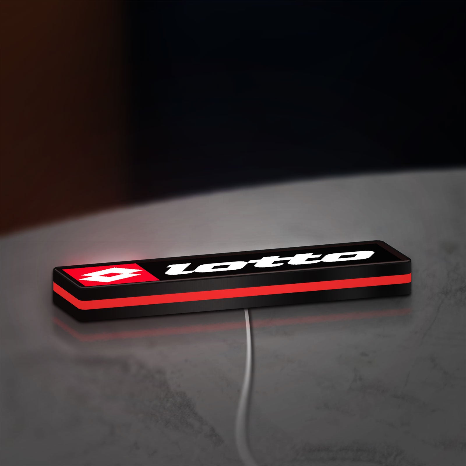 Lotto LED lightbox lying flat on a desk with red glow