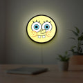 Sponge Bob LED lightbox hanging on a room wall with soft yellow light