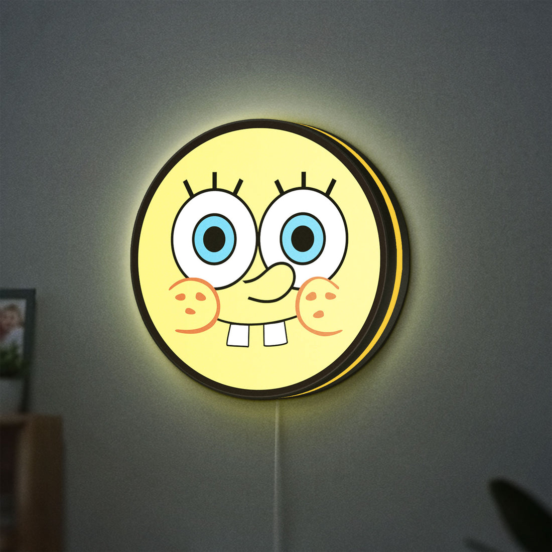 Sponge Bob LED lightbox hanging on a wall with yellow glow