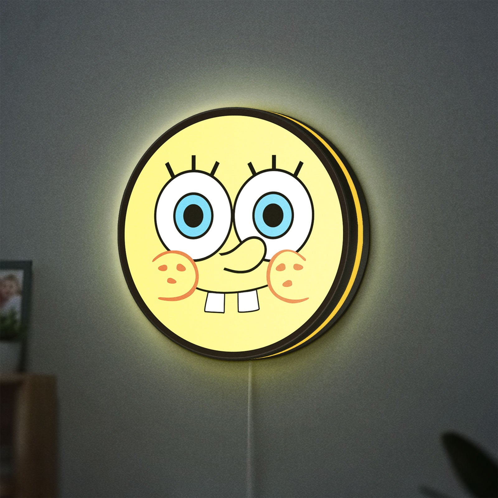 Sponge Bob LED lightbox hanging on a wall with yellow glow