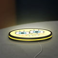 Sponge Bob LED lightbox lying flat on a desk with yellow glow