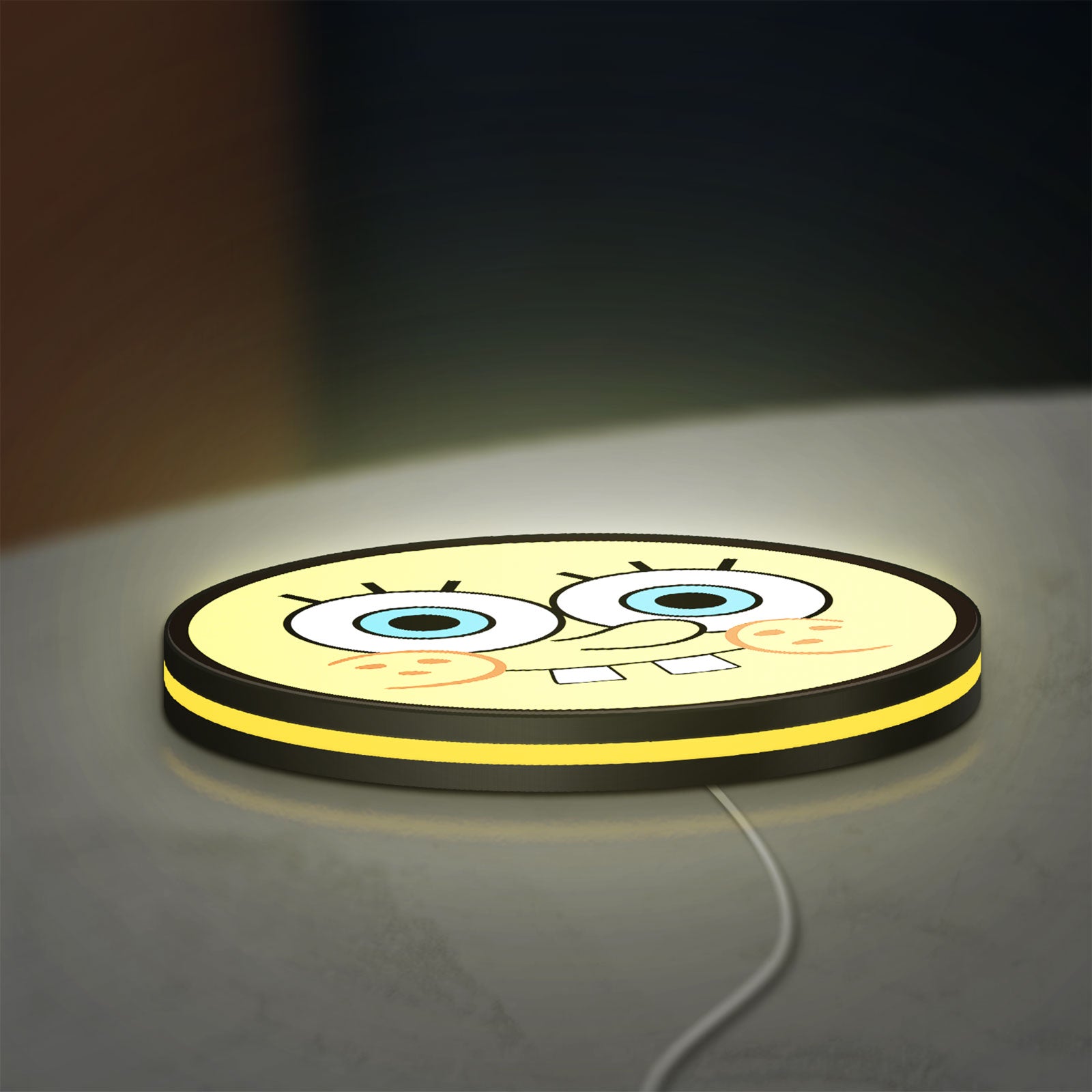 Sponge Bob LED lightbox lying flat on a desk with yellow glow
