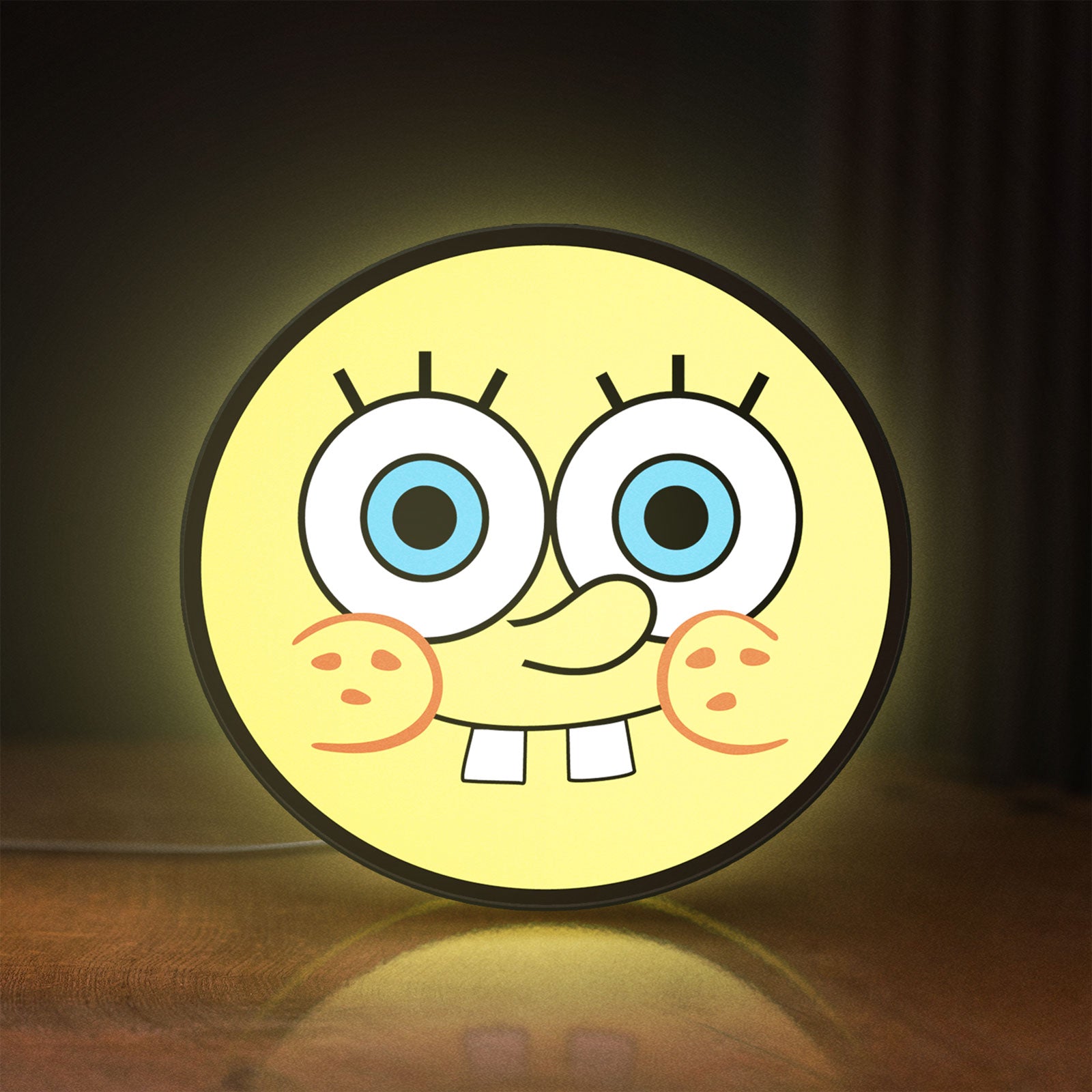 Front view of Sponge Bob LED lightbox sign glowing on a wooden desk
