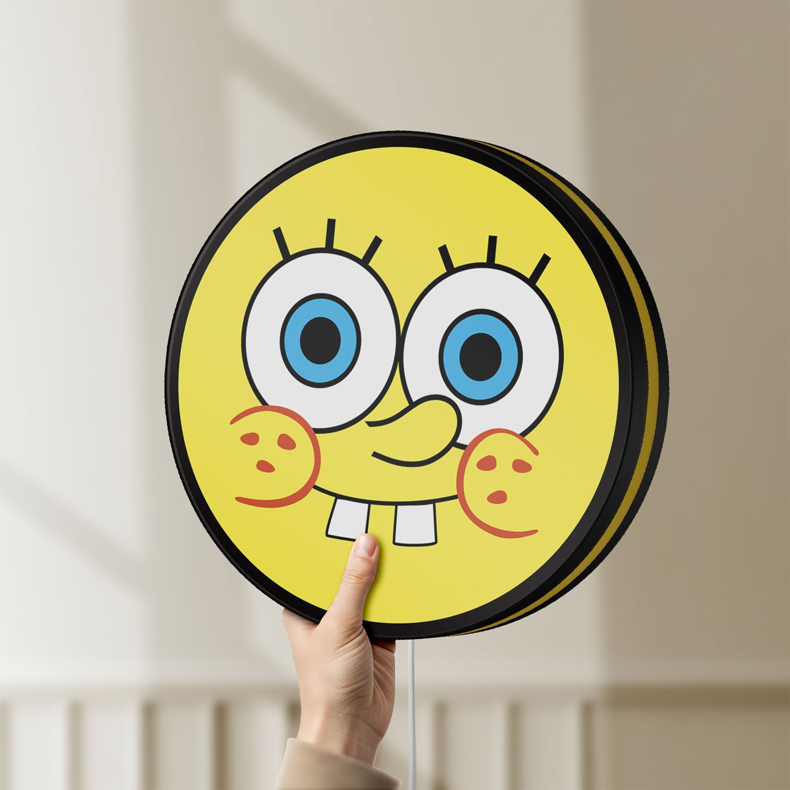 Unlit Sponge Bob LED lightbox held by hand to show size and details