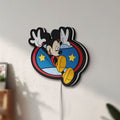 Unlit Mickey Mouse LED lightbox mounted on a wall in daylight