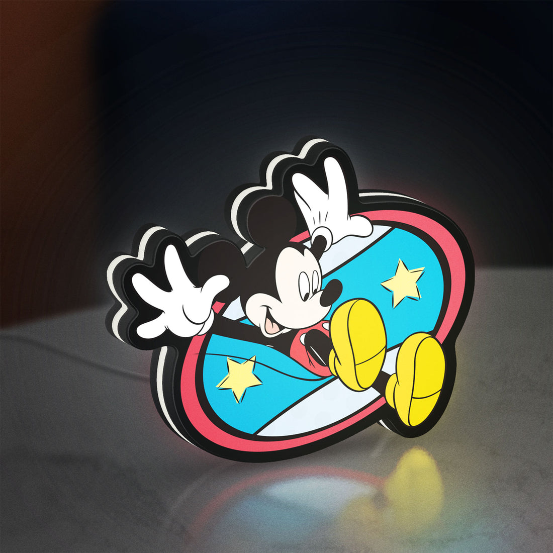 Mickey Mouse LED lightbox hanging on a wall with white glow