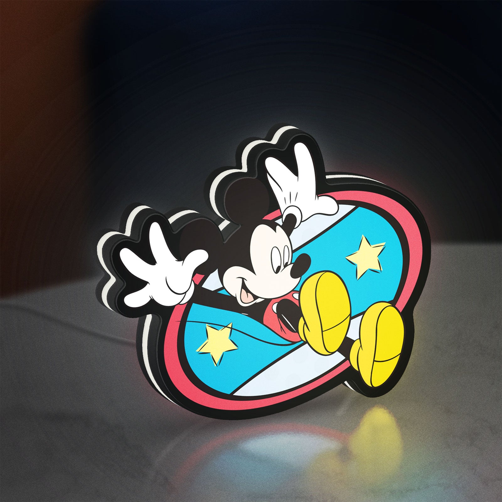 Mickey Mouse LED lightbox standing on a desk from an angled side view with white glow