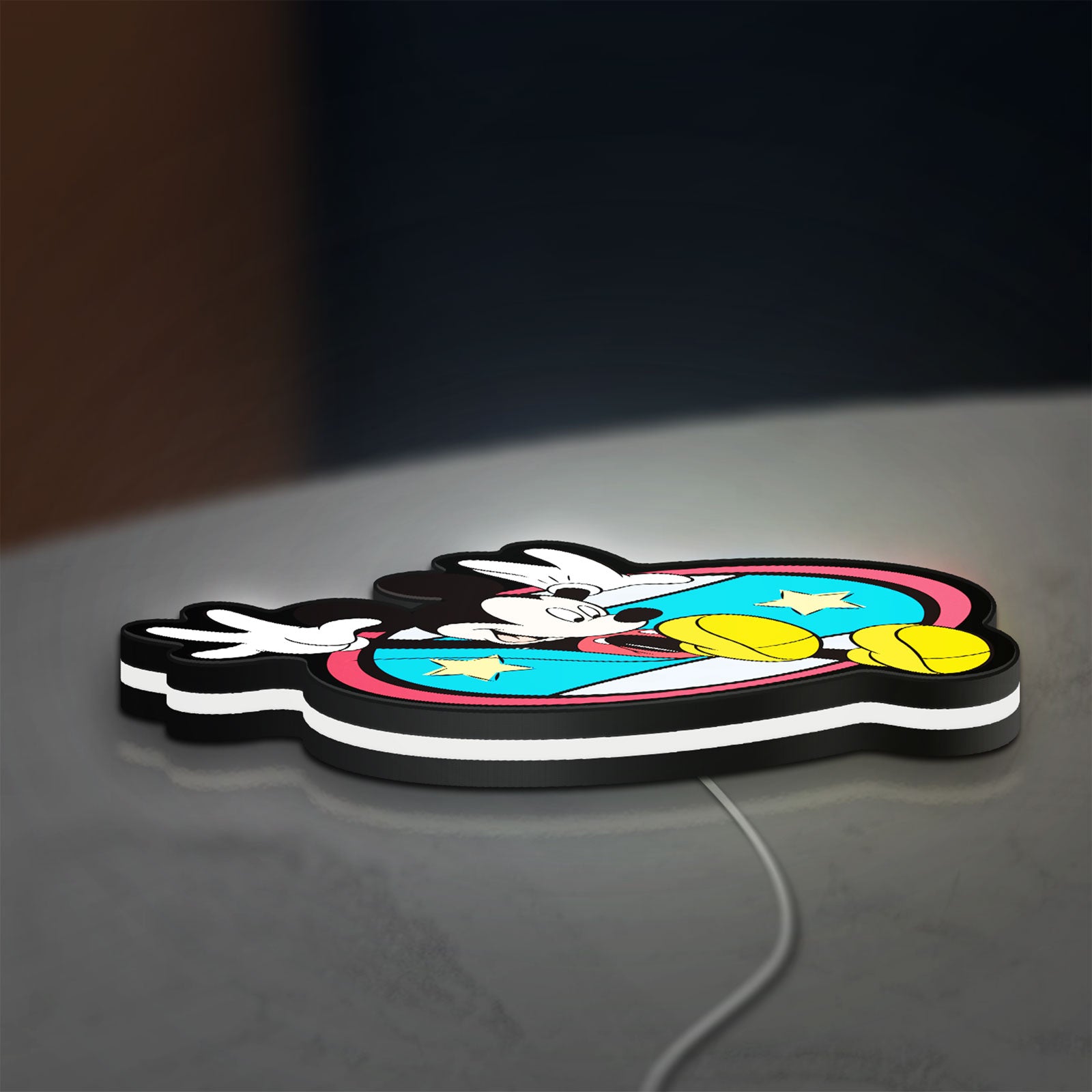 Mickey Mouse LED lightbox lying flat on a desk with white glow