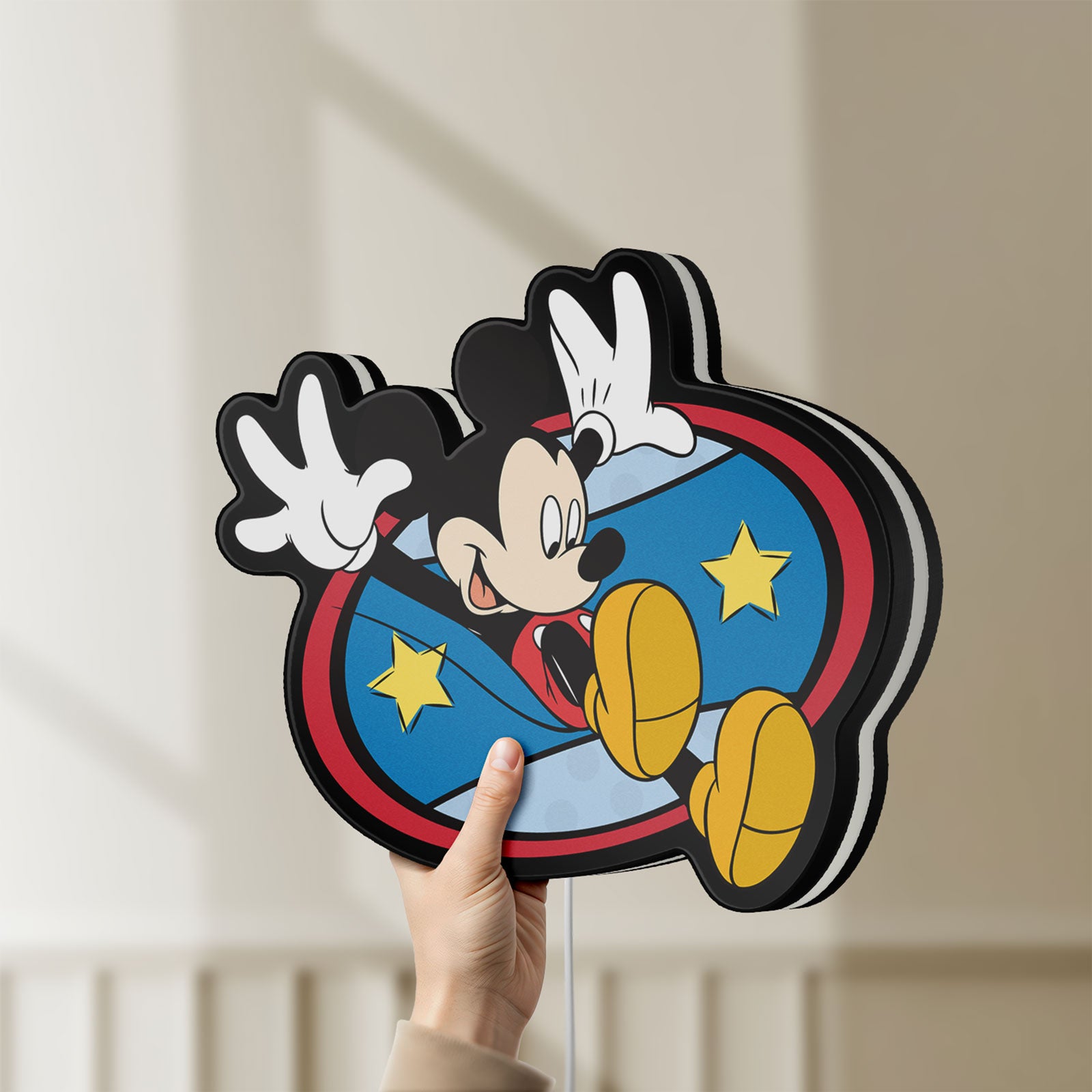 Unlit Mickey Mouse LED lightbox held by hand to show size and details