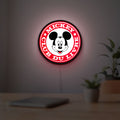 Mickey Club Du Livre LED lightbox hanging on a room wall with soft red light