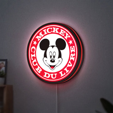 Mickey Club Du Livre LED lightbox hanging on a wall with red glow