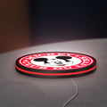 Mickey Club Du Livre LED lightbox lying flat on a desk with red glow