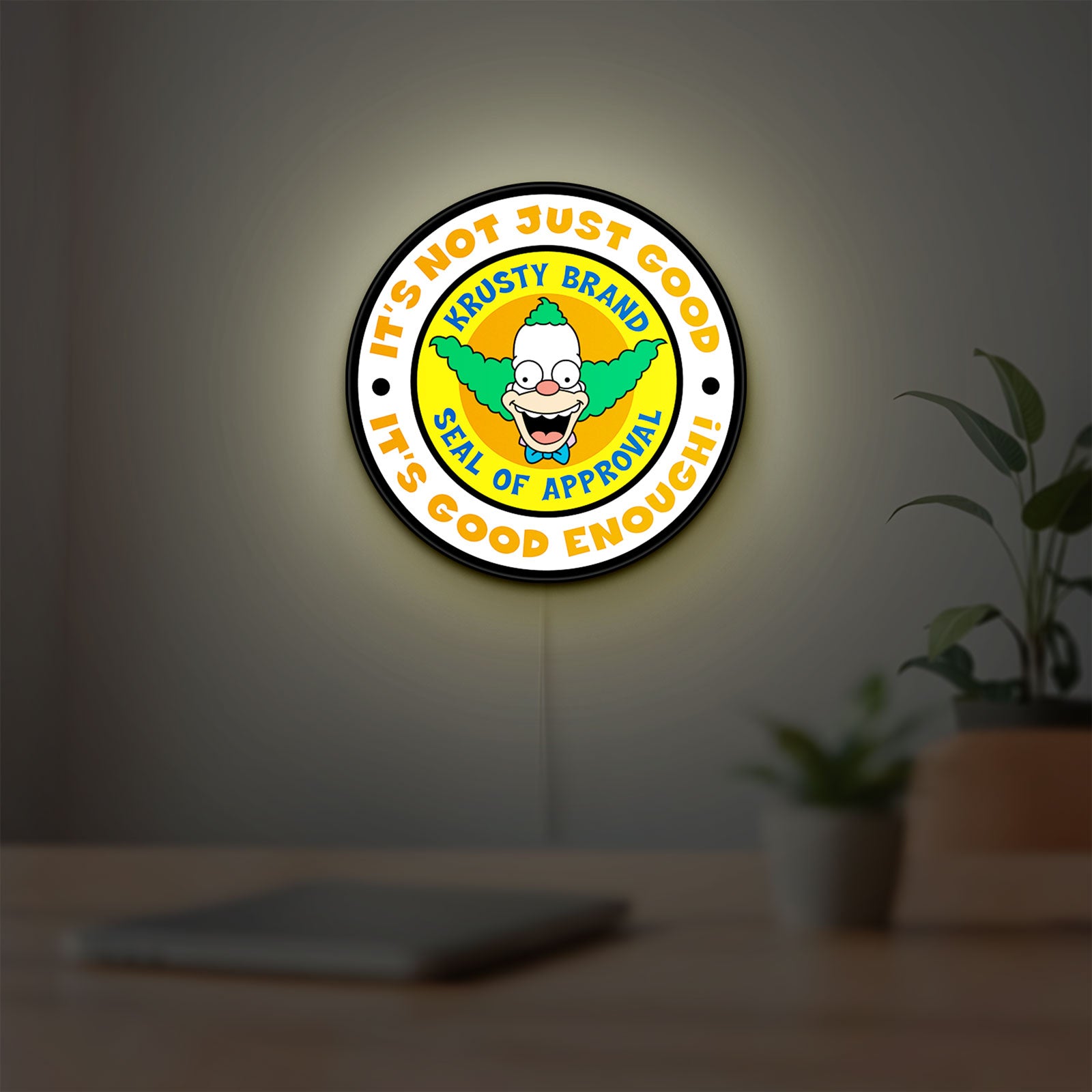 The Simpsons LED lightbox hanging on a room wall with soft white light